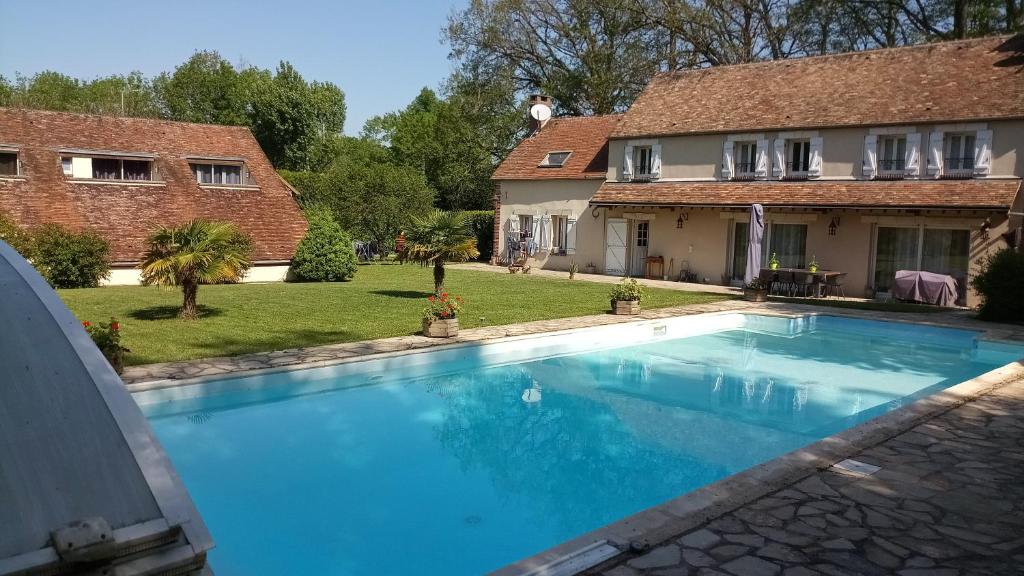 a swimming pool in front of a house at Villa Dikaria in Montacher
