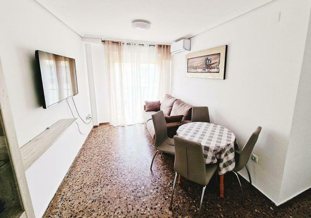 a living room with a couch and a table at Carmen Apartments in Benidorm