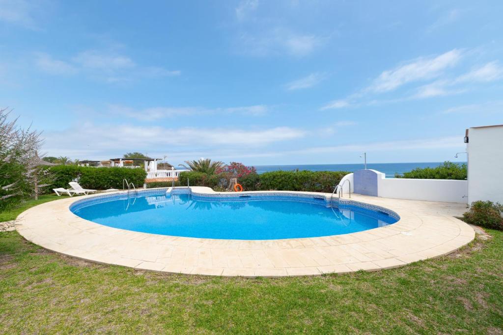 a swimming pool in the yard of a house at Casa Siloam in Torrox Costa
