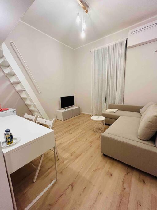 a living room with a couch and a table at Studio Apartment Near Bocconi in Milan