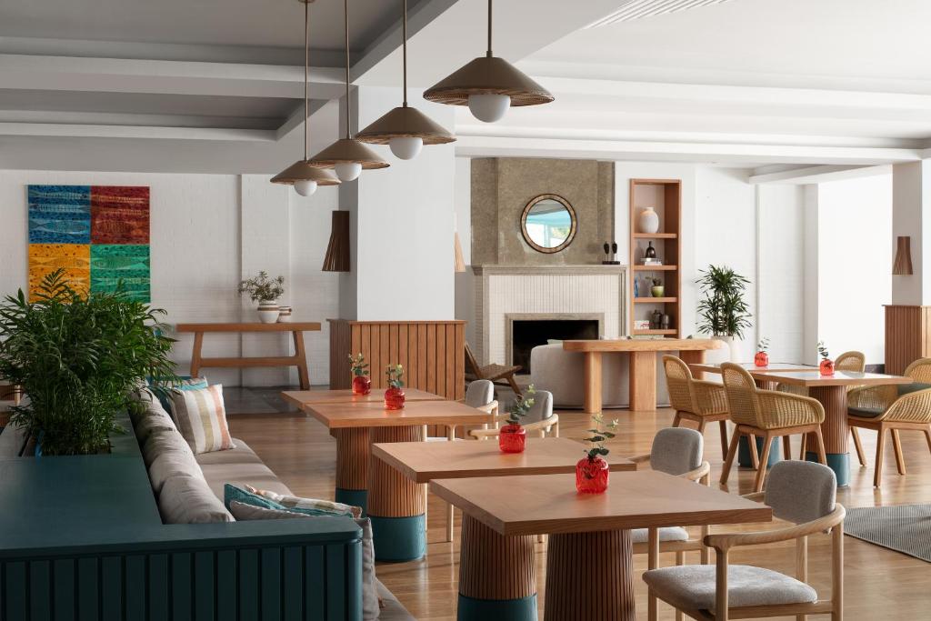 a restaurant with tables and chairs and a fireplace at Doria Hotel Bodrum-City Center in Bitez