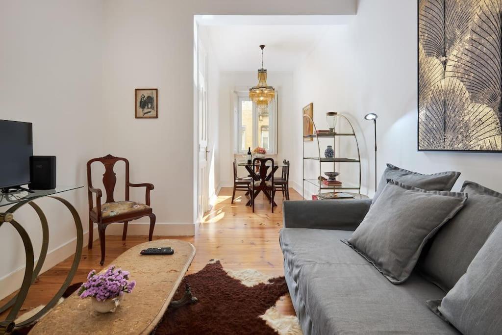 a living room with a couch and a table at Charming Lisbon Central Apartment in Lisbon