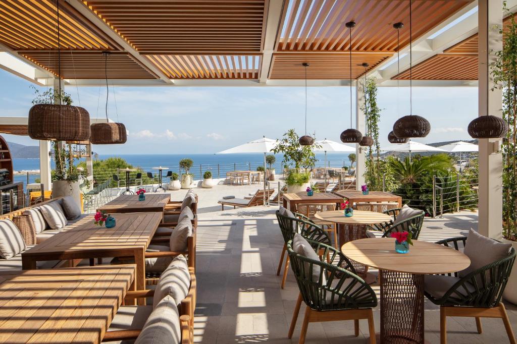 a restaurant with tables and chairs and a view of the ocean at Doria Hotel Bodrum-City Center in Bitez