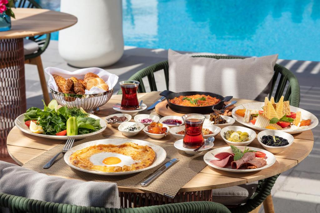 a table with plates of food on top of it at Doria Hotel Bodrum-City Center in Bitez
