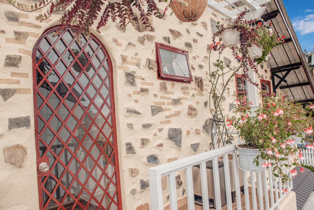 a stone building with a window and flowers on it at Villa Hoa Da in Da Lat