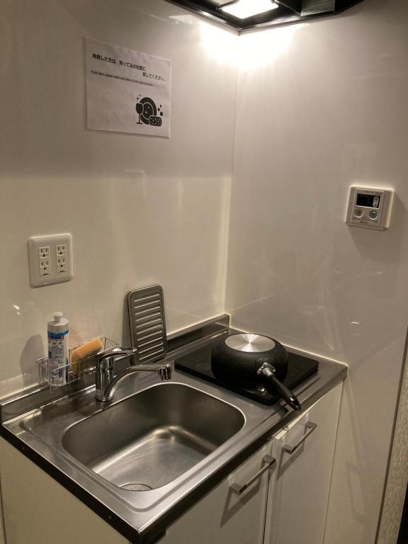 Kuchyň nebo kuchyňský kout v ubytování Hostel LodgingToyko Minowa