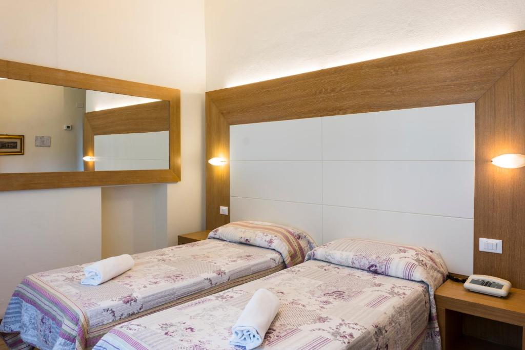 Postel nebo postele na pokoji v ubytování Hotel Sylvia