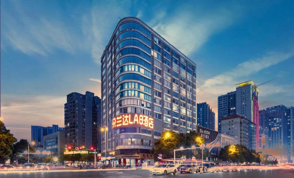 a tall building with a sign on it in a city at Doaland Lab Hotel, Wuyi Plaza South Gate Metro Station in Changsha