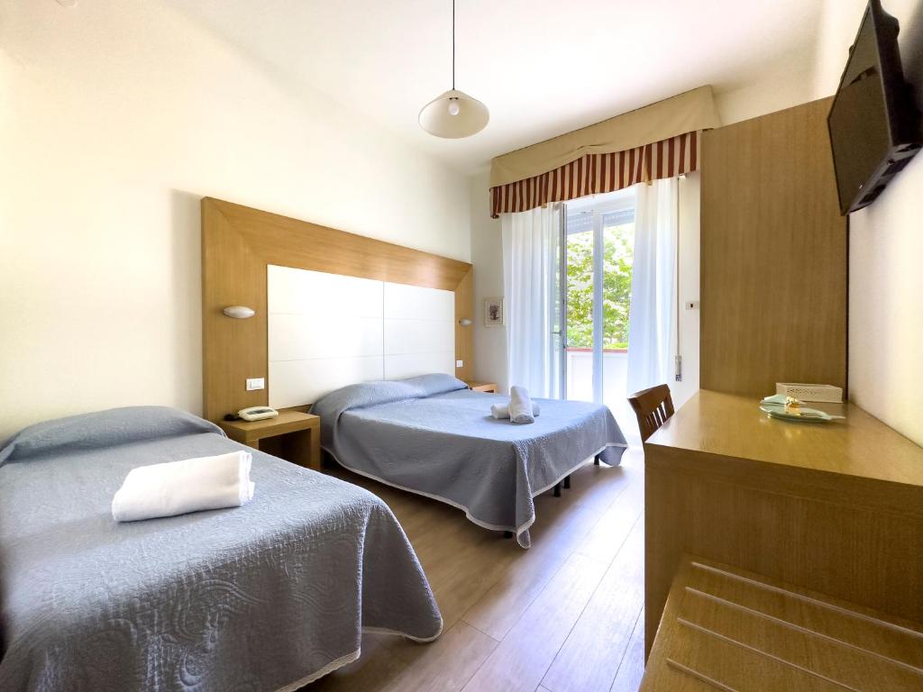 Postel nebo postele na pokoji v ubytování Hotel Sylvia