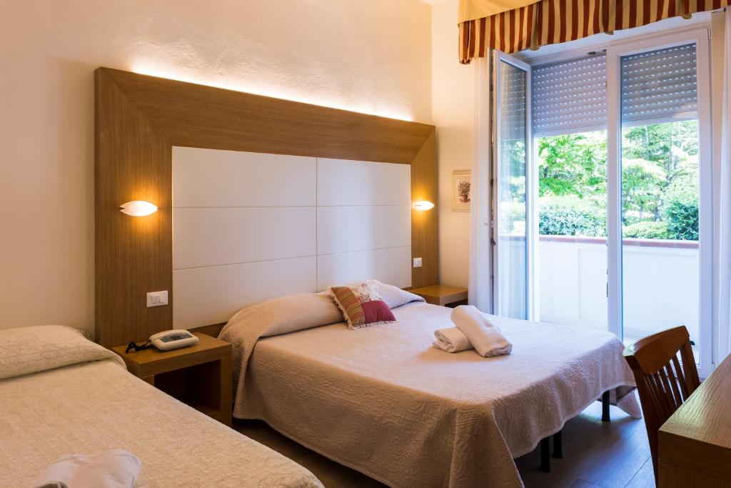 Postel nebo postele na pokoji v ubytování Hotel Sylvia