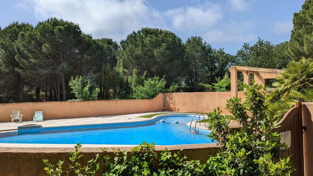 a swimming pool in a backyard with a fence at Cigale 5 in Argelès-sur-Mer