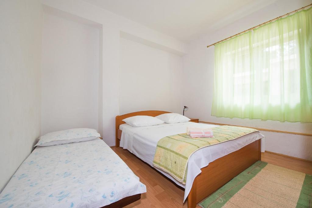 Postel nebo postele na pokoji v ubytování Apartments Remini