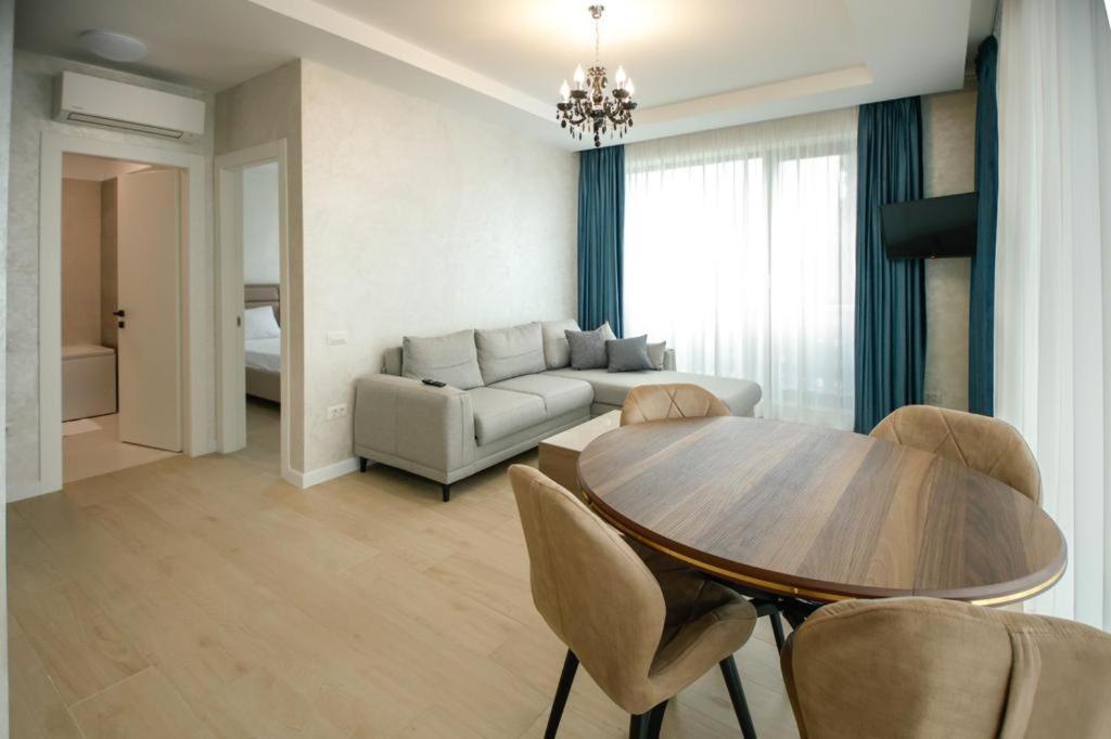 a living room with a table and a couch at Lake On Apartments in Mamaia