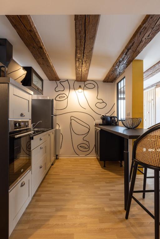 une cuisine avec un mur orné de dessins. dans l'établissement Gite Pomme de Reinette, à Urschenheim