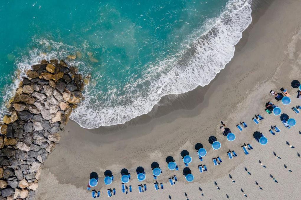 an overhead view of a beach with umbrellas and the ocean at Hotel La Principessa in Campora San Giovanni