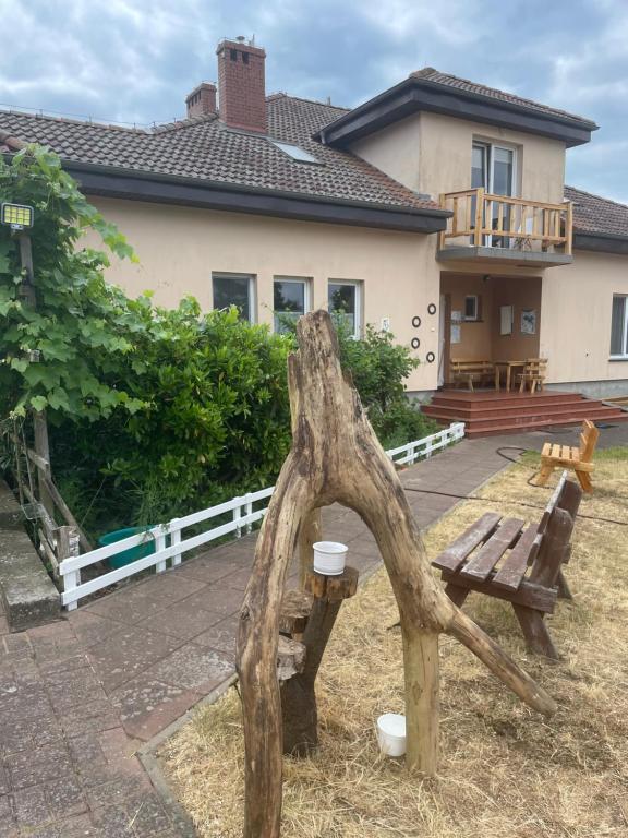 a wooden bench in front of a house at Kopice " Kowalczyk Hotel Residences In Nature Parks " in Gollnow