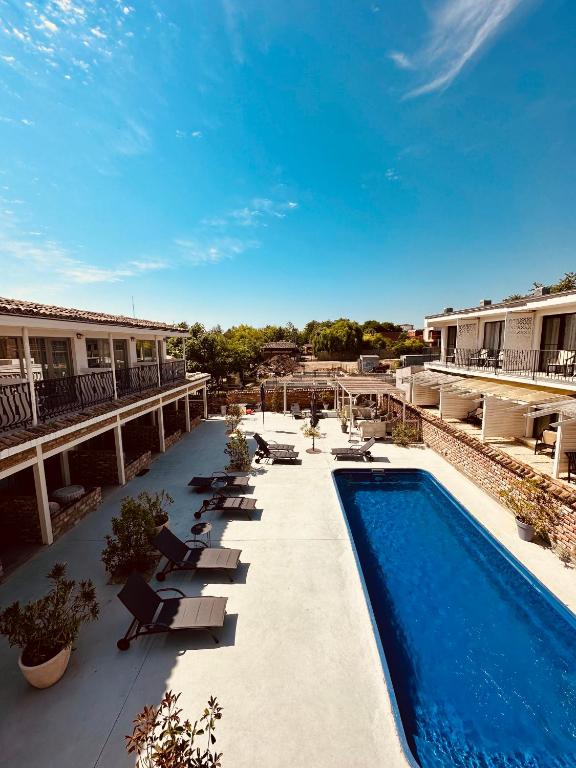 a resort with a swimming pool and lounge chairs at Vamyami Vama Veche in Vama Veche