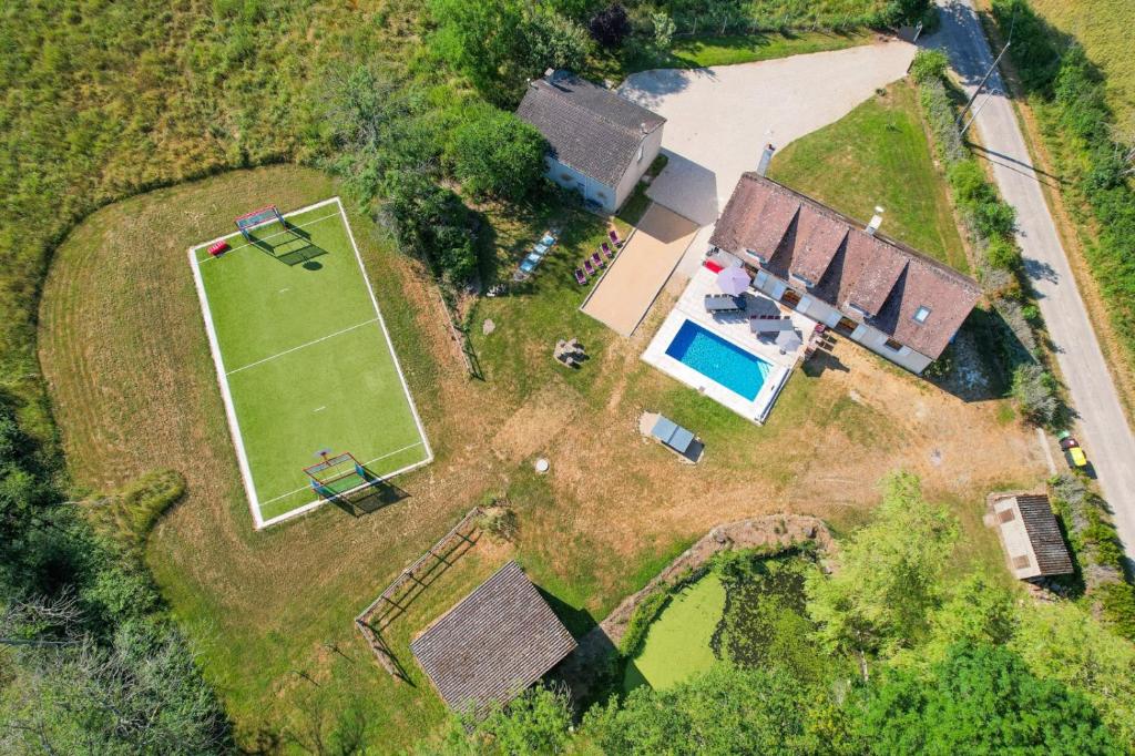 an aerial view of a house with a tennis court at Crazy Villa Gaudiniere 89 - Heated pool - Multisport - 2h Paris - 30p in Champcevrais