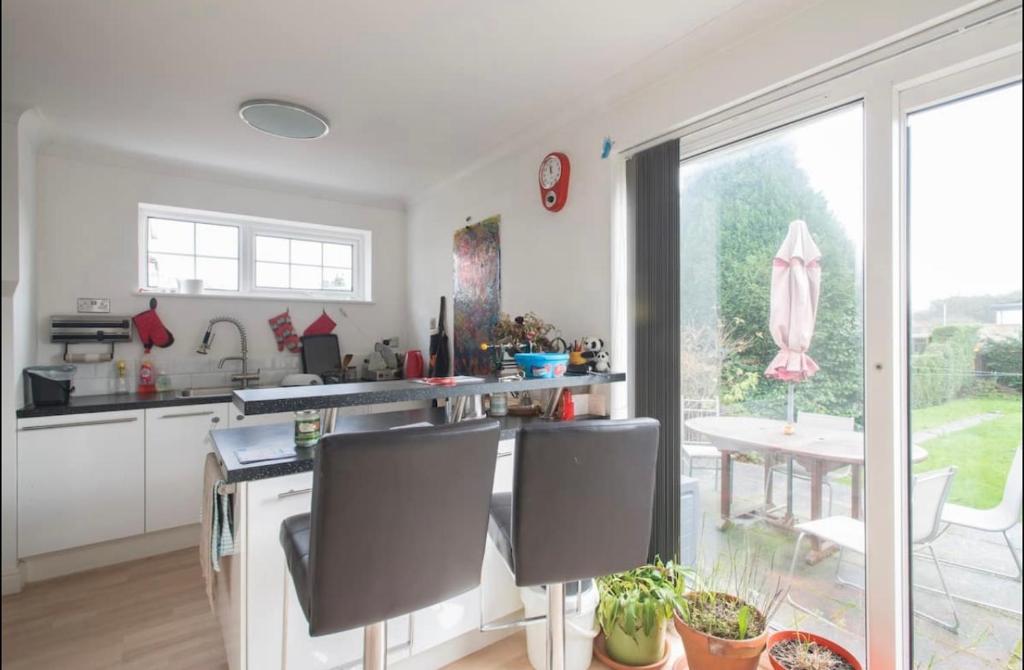 a kitchen with a counter and a table with chairs at Home from home Norwich centre in Norwich