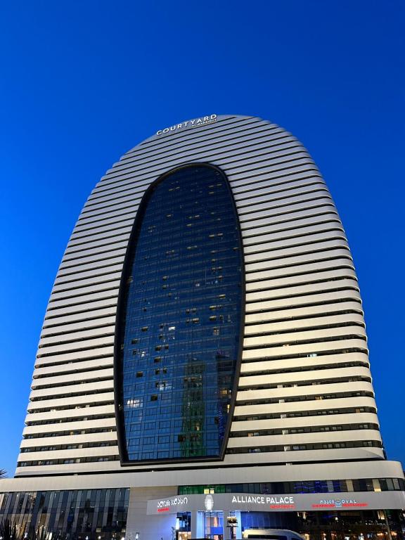 a tall building with a large window on it at Batumi Continental apartments in Batumi