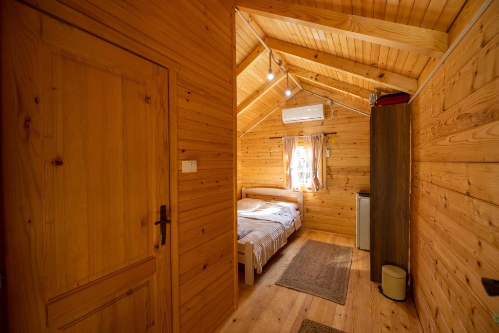a bedroom with a bed in a wooden room at Via river in Podgorica