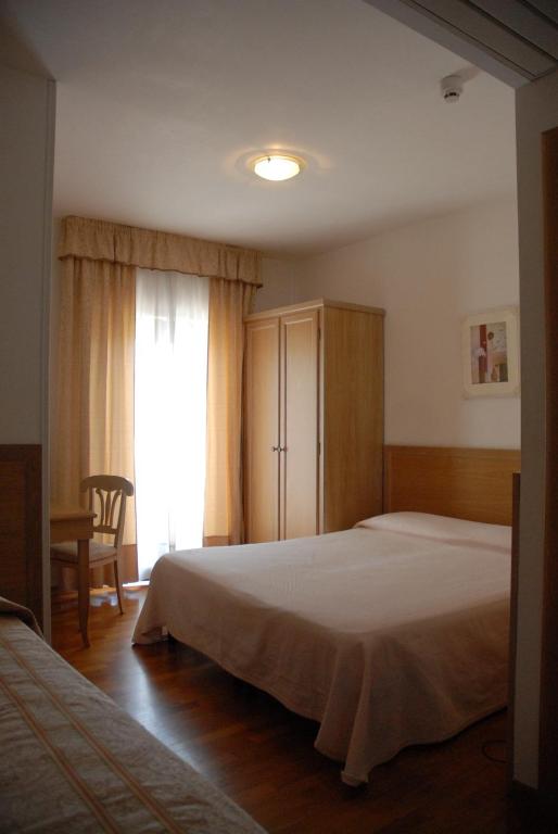 Postel nebo postele na pokoji v ubytování Hotel Donatello