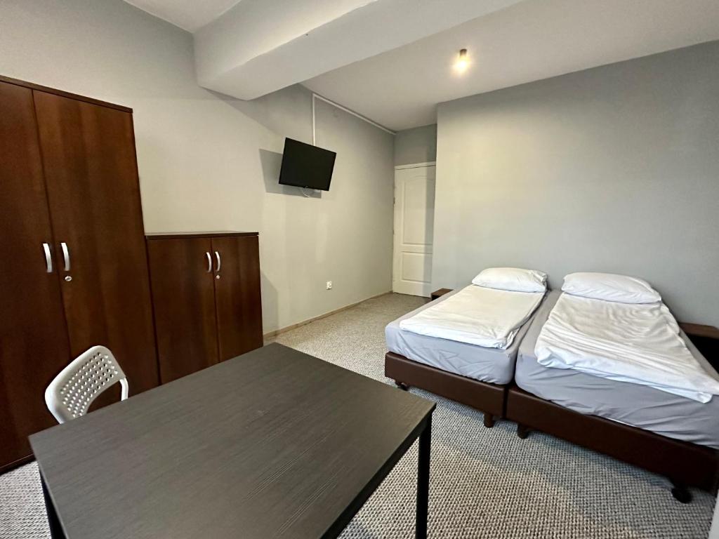 Ένα ή περισσότερα κρεβάτια σε δωμάτιο στο BLUE Hostel - Private Rooms - Centrum Poznan