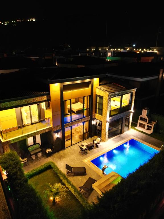 an aerial view of a house with a swimming pool at night at SAPANCA ALHARRAN VILLA in Sapanca