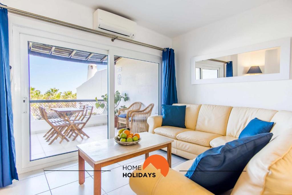 a living room with a couch and a table at #088 2BR São Rafael Pool & Beach Nearby in Albufeira