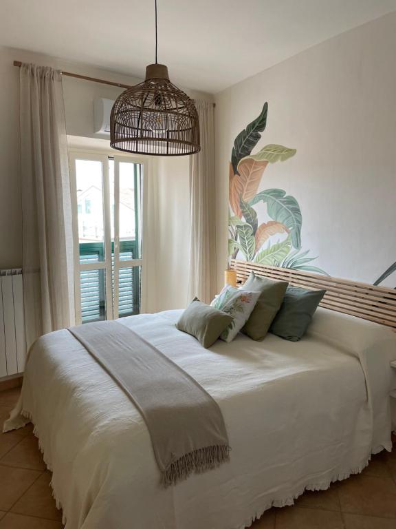 a bedroom with a large white bed with a large window at Casa Bucciarelle in Casoli