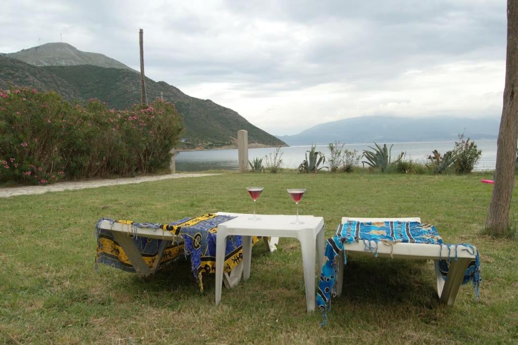 a table with two wine glasses sitting on top of a field at Seaside Villa in Káto Vasilikí