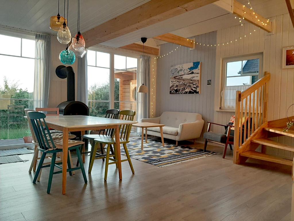 ein Wohnzimmer mit einem Tisch und Stühlen in der Unterkunft Annemarie Zerpenschleuse - Schwedenhaus mit Künstler-Charme und Sauna in Zerpenschleuse
