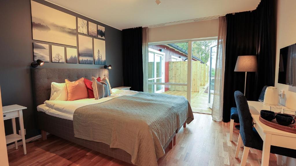 een slaapkamer met een bed, een bureau en een raam bij Bedinge Golfklubb hotell in Beddinge Strand