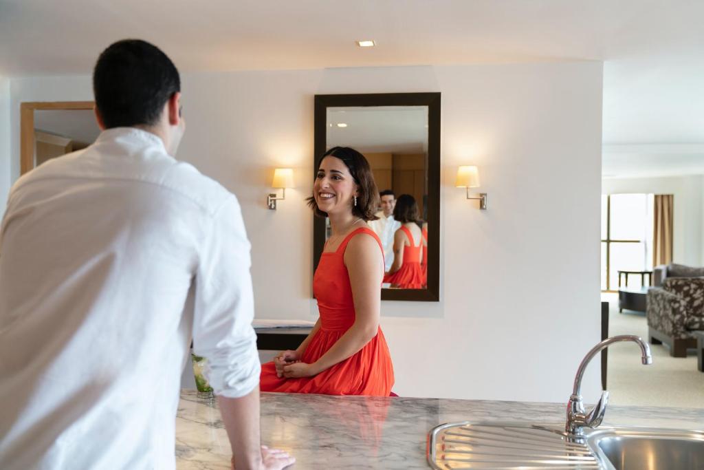 A marble counter overlooking a furnished hotel suite.