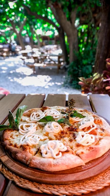 a pizza sitting on top of a wooden table at Sheriff, Olympos in Kumluca