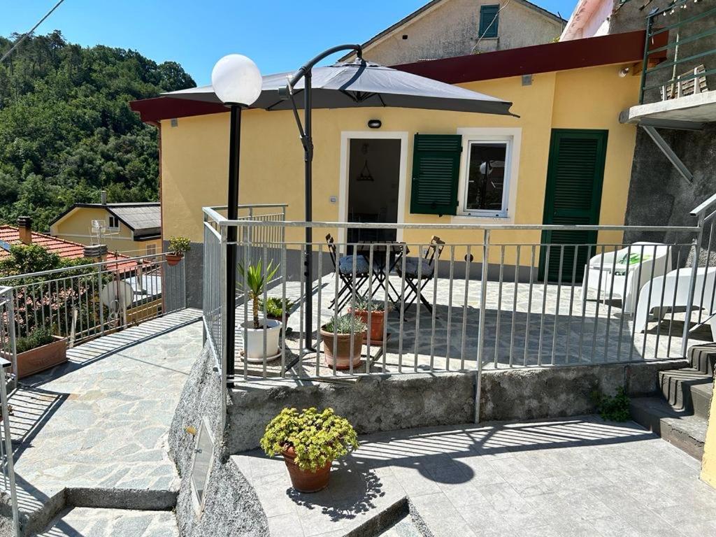 a balcony of a house with a fence and plants at Da Pippo in Moneglia