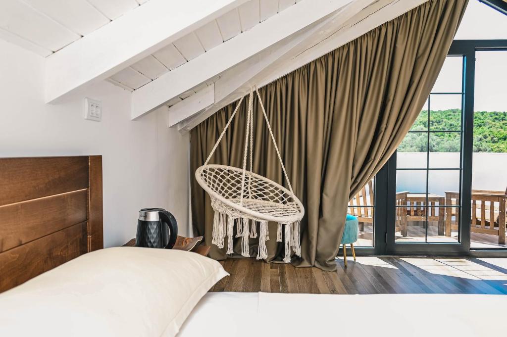 a bedroom with a bed and a chair at MASHTRA - The Olive House in Ulcinj