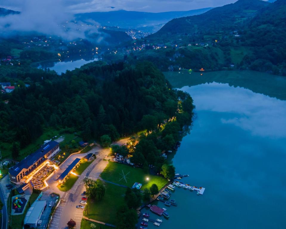 an aerial view of a lake at night at Hotel Plivsko jezero in Jajce