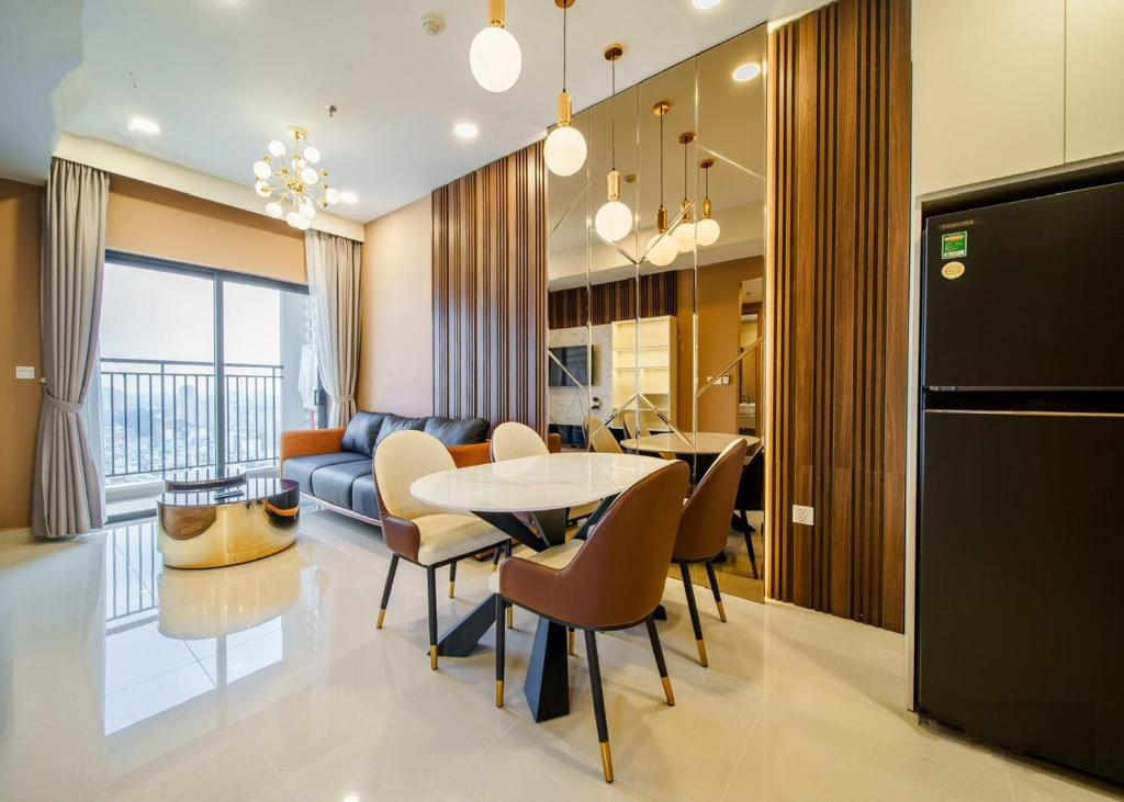 a kitchen and living room with a table and chairs at SMILE HOME - SOHO APARTMENT COMFORTABLE - BEST LOCATION district 1 in Ho Chi Minh City