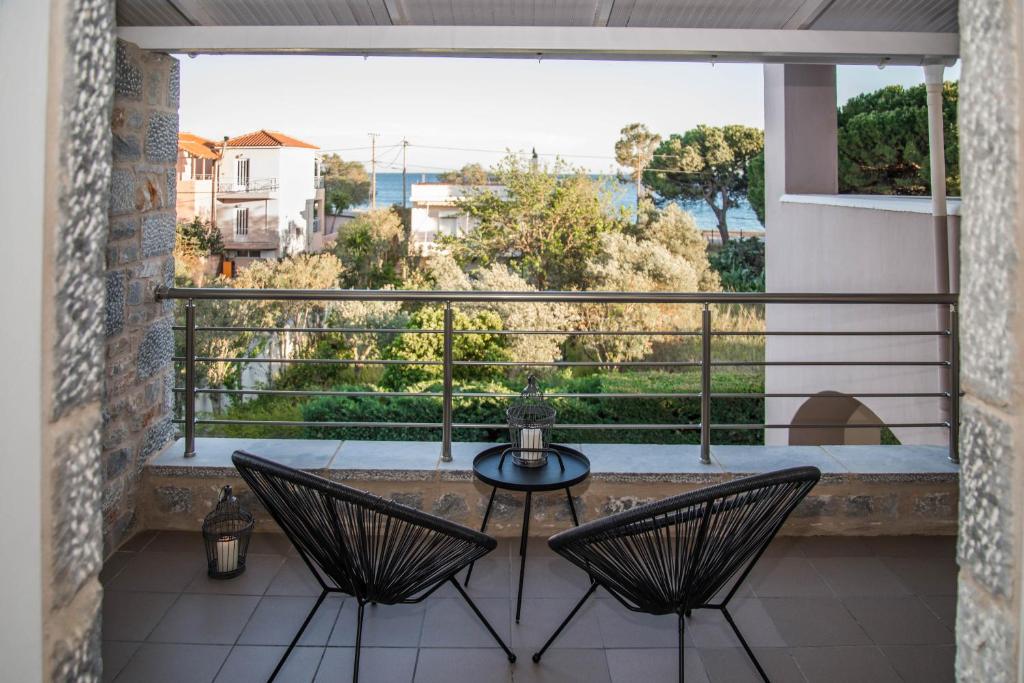 a balcony with two chairs and a table on a balcony at Diamond Palace in Gythio