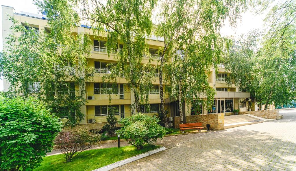 an apartment building with a bench in front of it at Sovinyon Resort in Odesa