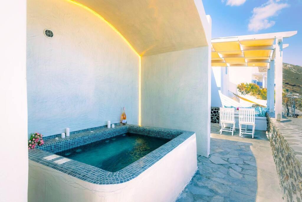 a swimming pool in a house with a rainbow on it at Sylvia's Villa in Imerovigli