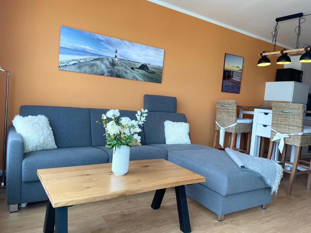 a living room with a couch and a table at Frische Brise FeWo12 09 in Cuxhaven