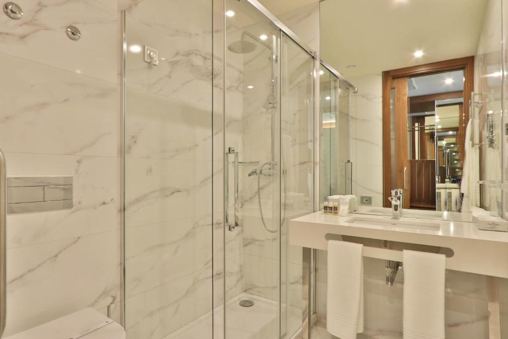 a bathroom with a shower and a sink at TURIM Ibéria Hotel in Lisbon