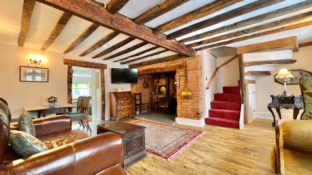 a living room with a couch and a fireplace at Cosy Cottage in Wellington