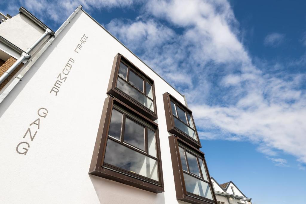 a white building with windows and the sky in the background at Prümer Gang Restaurant & Hotel in Bad Neuenahr-Ahrweiler