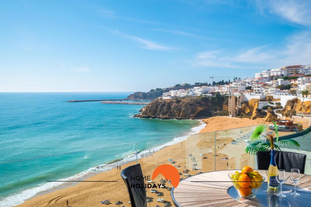 a view of a beach with a table and the ocean at #041 Private Beach View, High Speed WiFi, 20 mts Beach in Albufeira