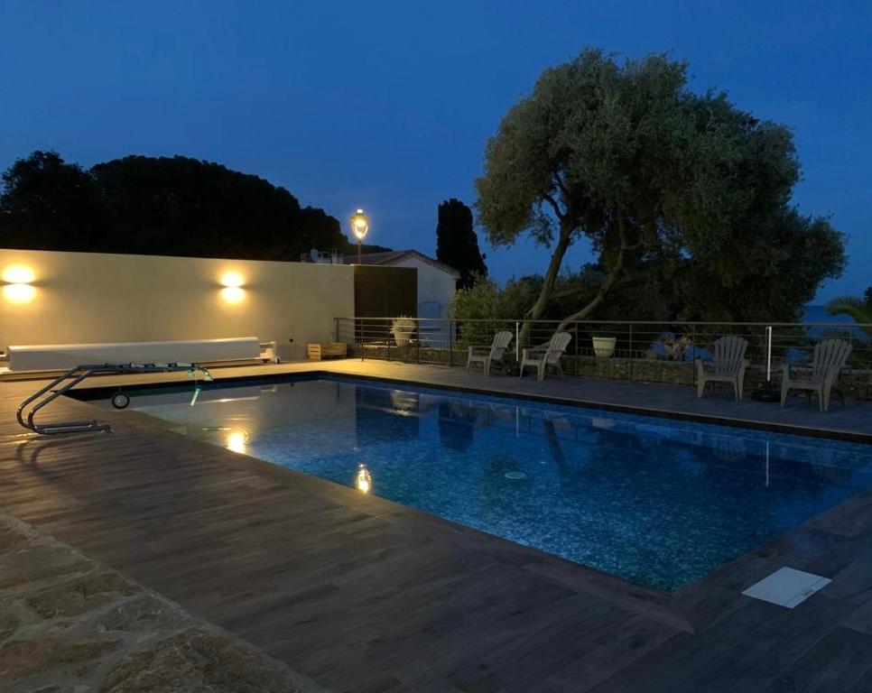 a swimming pool with lights in the middle of it at Hotel Cyrnea in Bastia