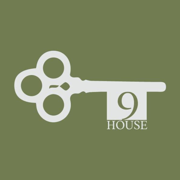 a logo for a house with a pair of scissors at 9 House in Fethiye