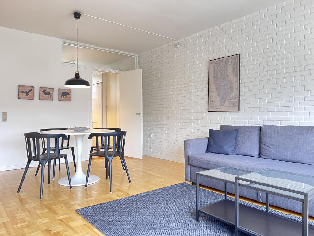 a living room with a couch and a table at Apartment In Valby in Copenhagen